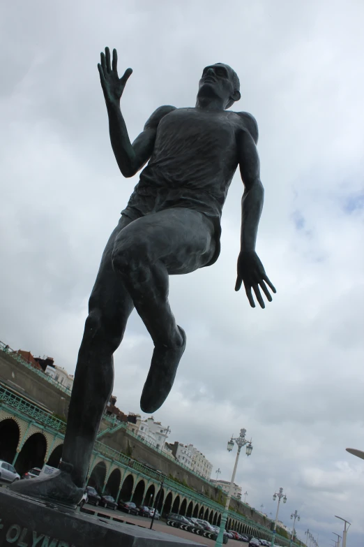 statue of a male athlete running in a stadium