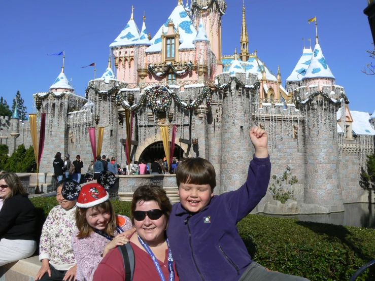 some people are posing in front of a castle