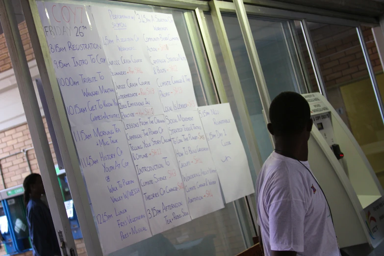 a man is writing on a whiteboard with many notes