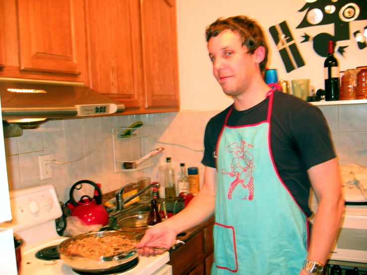 a man that is in the kitchen making some food