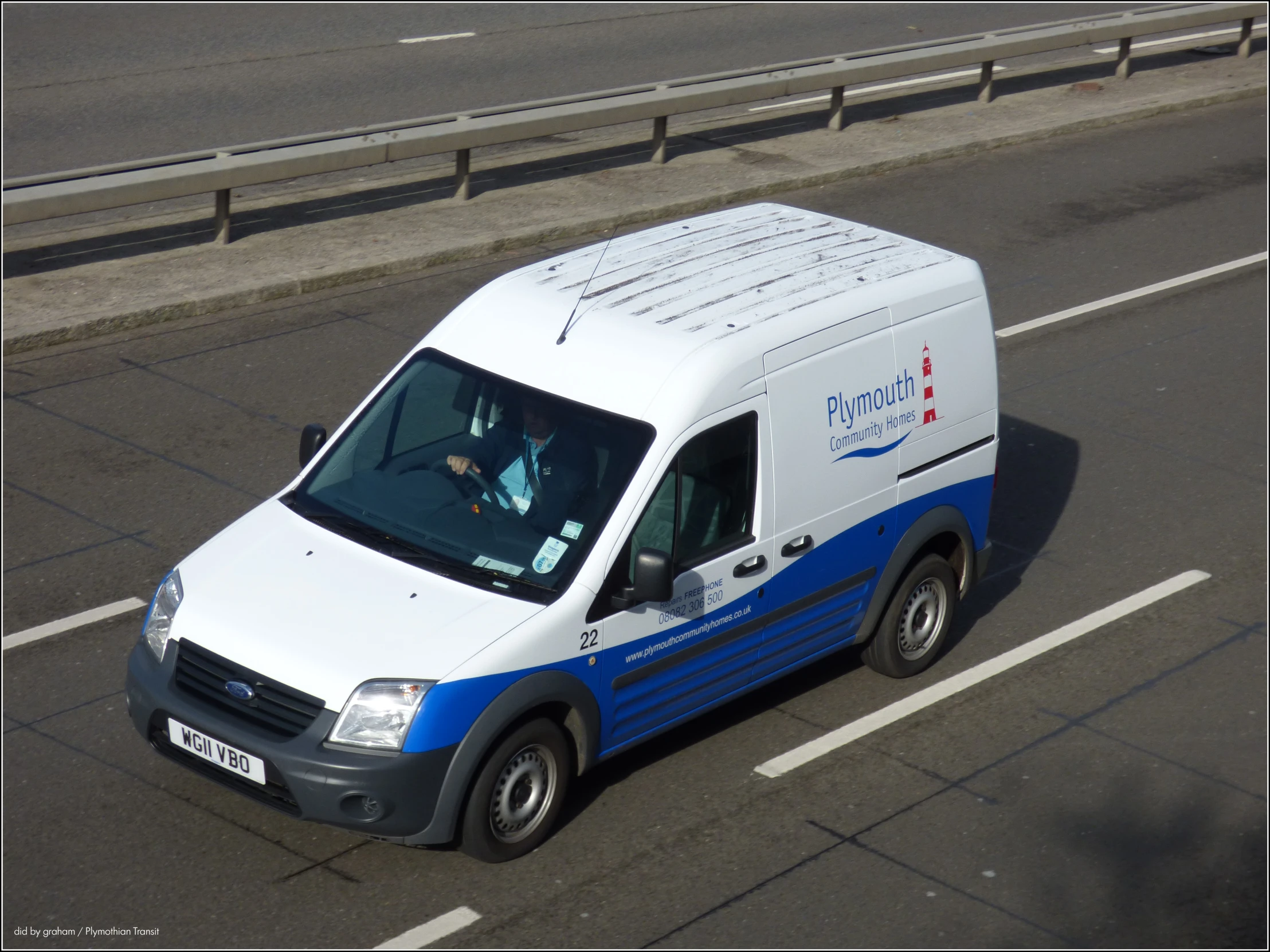 a van is driving down a road next to a highway divider