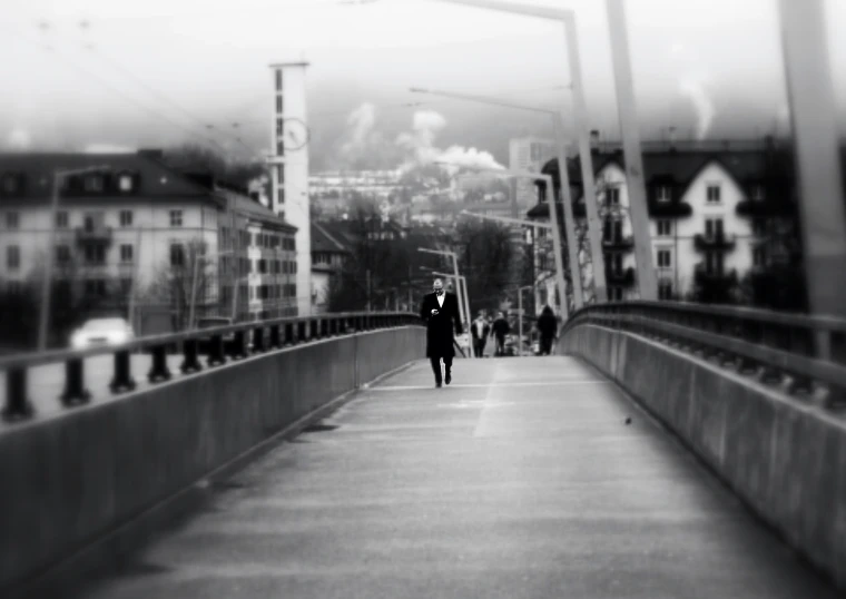 there is a man walking across a bridge