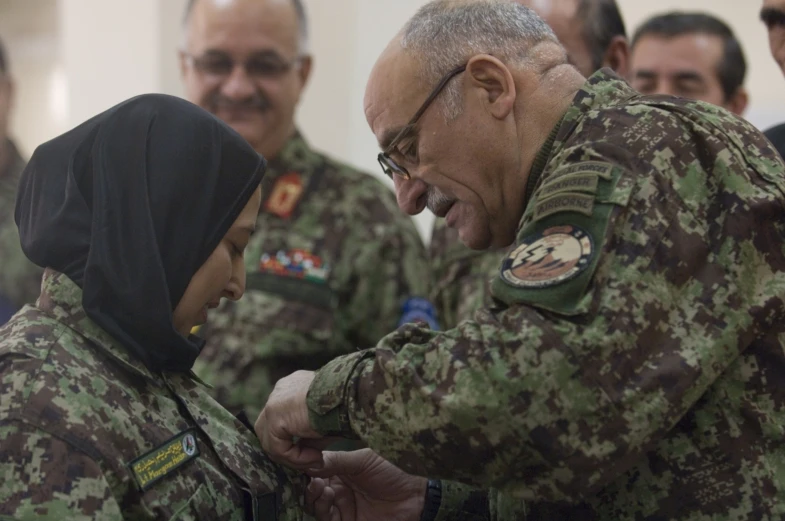 a couple of people in military uniforms shaking hands