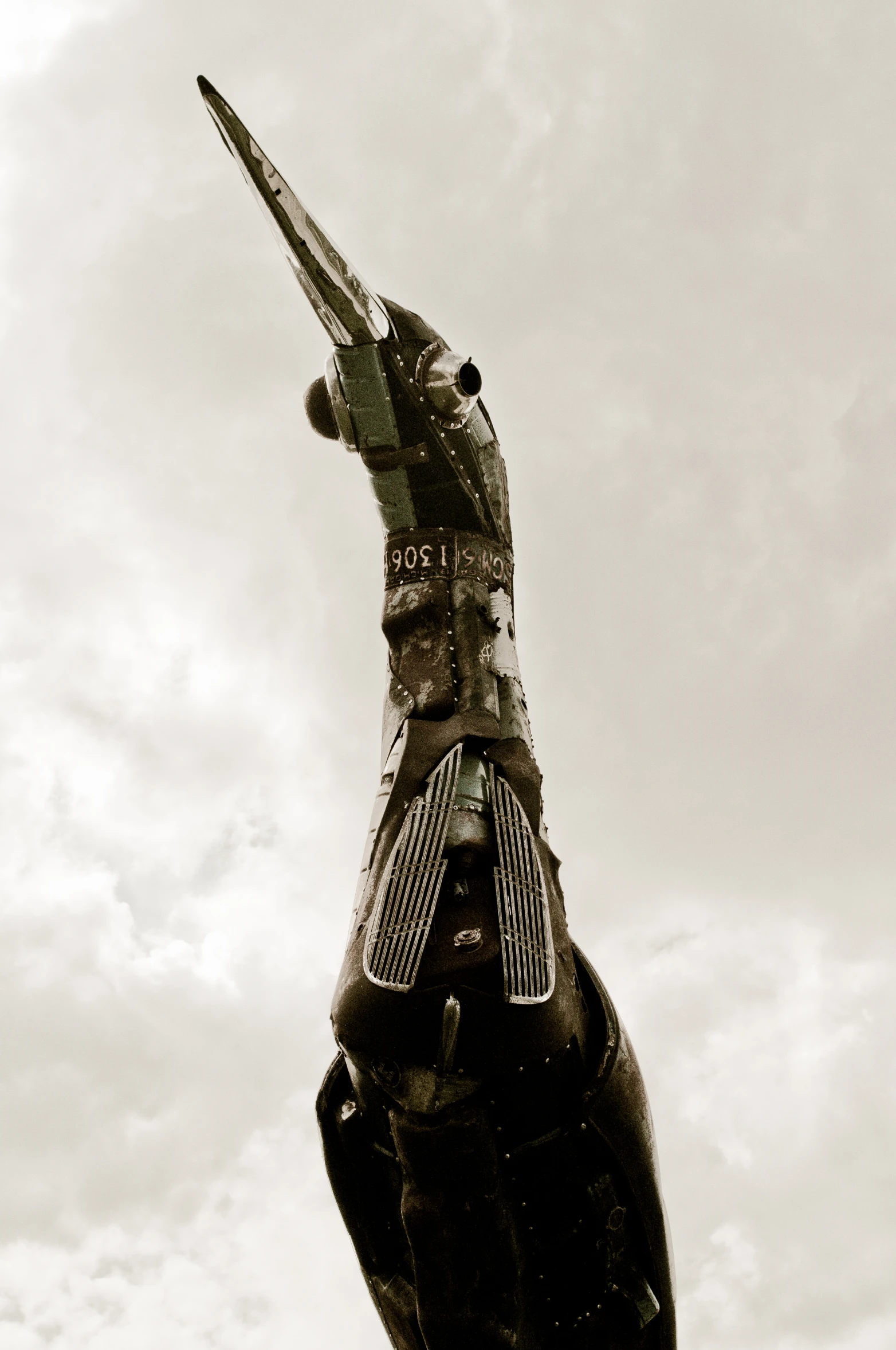 a jet is flying through the air with a statue