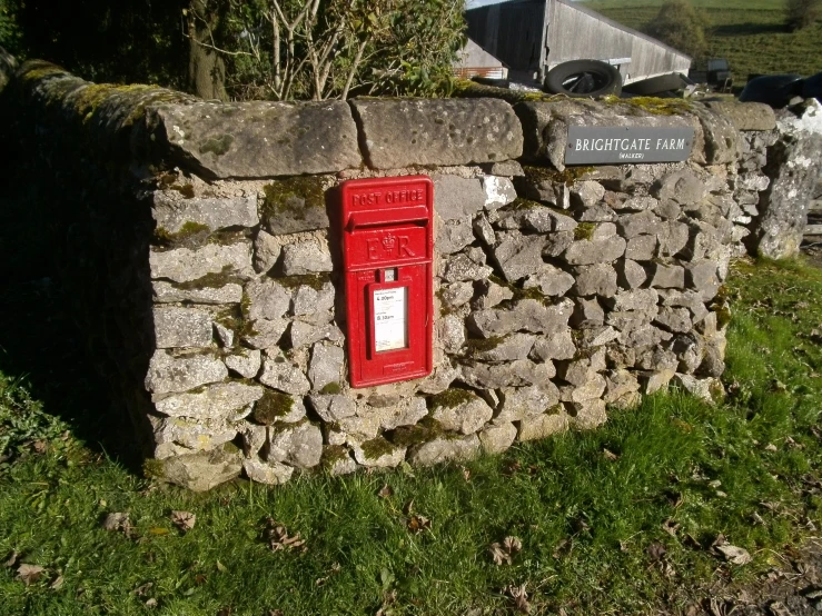 a post box mounted to a rock wall