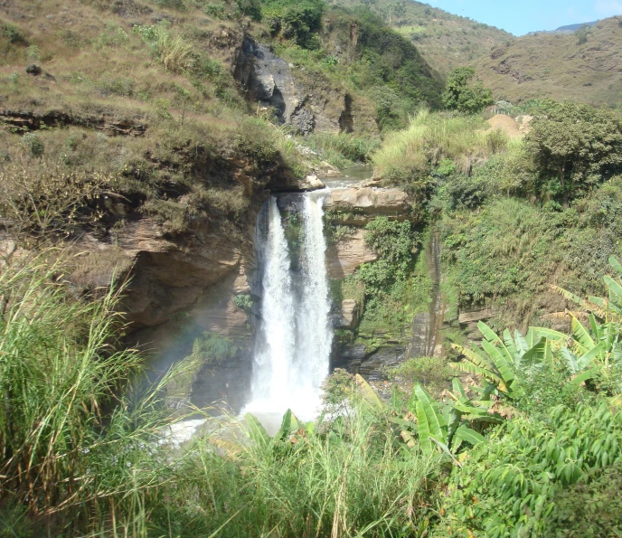 a small waterfall cascading into a deep rocky cliff