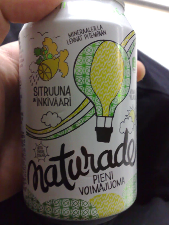 a person is holding a can of natural lemonade