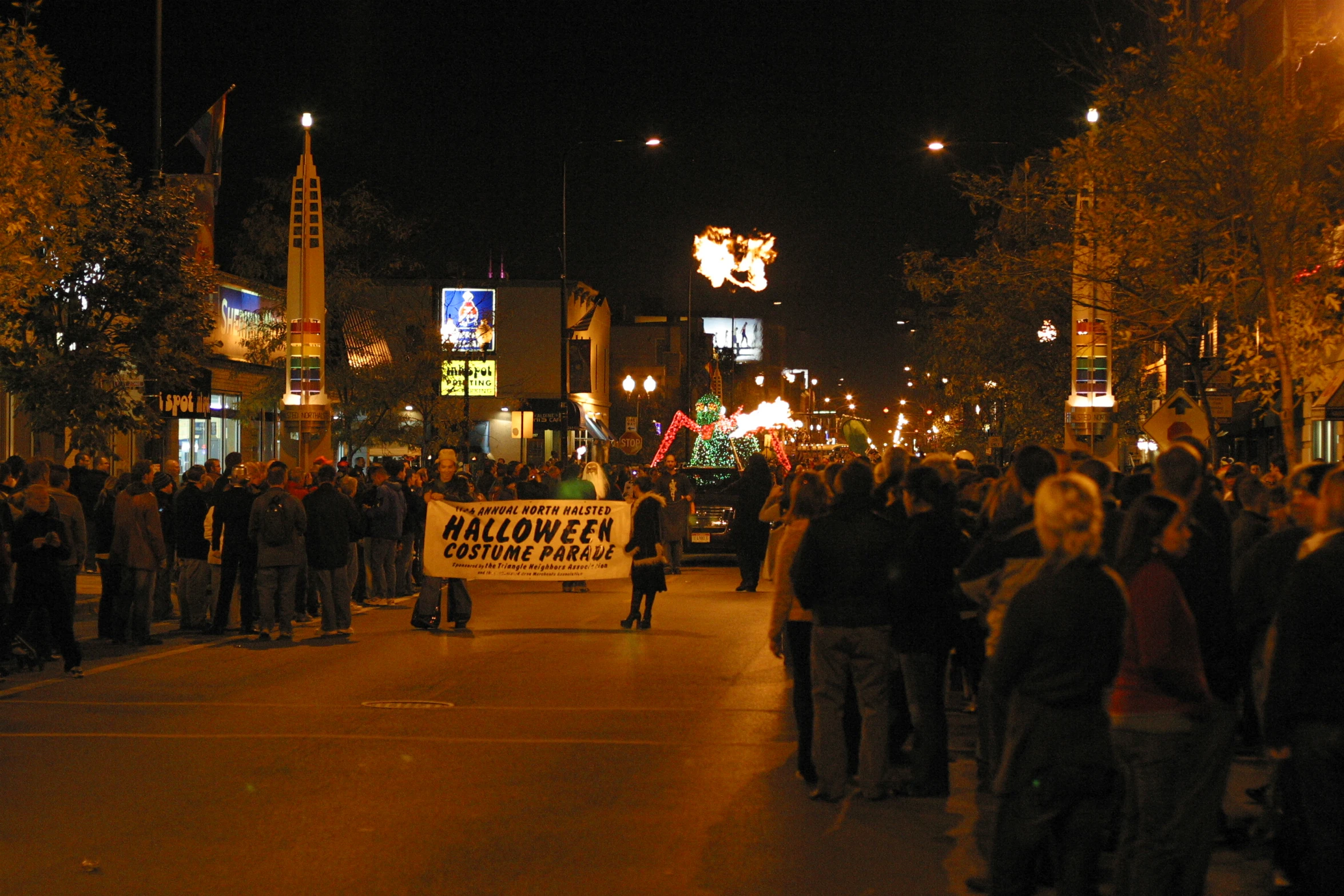 a large group of people gather on the sidewalk