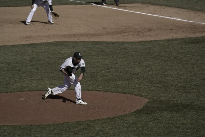 the baseball player is getting ready to pitch the ball