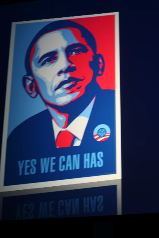the obama poster is hung on a pole