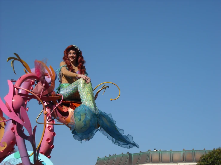 a woman riding a dragon kite in the air