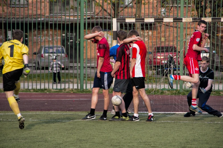 a group of men standing around a soccer ball