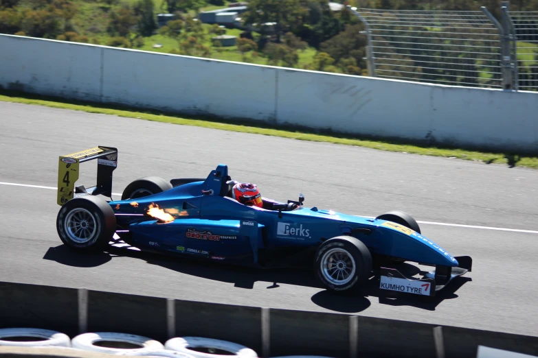 the racer drives his racing car around the track