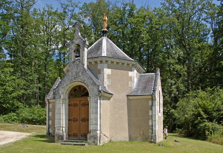 an old building in front of some trees