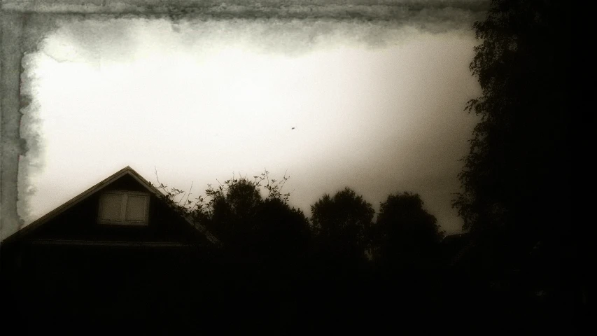 an abandoned house at dusk covered by smoke