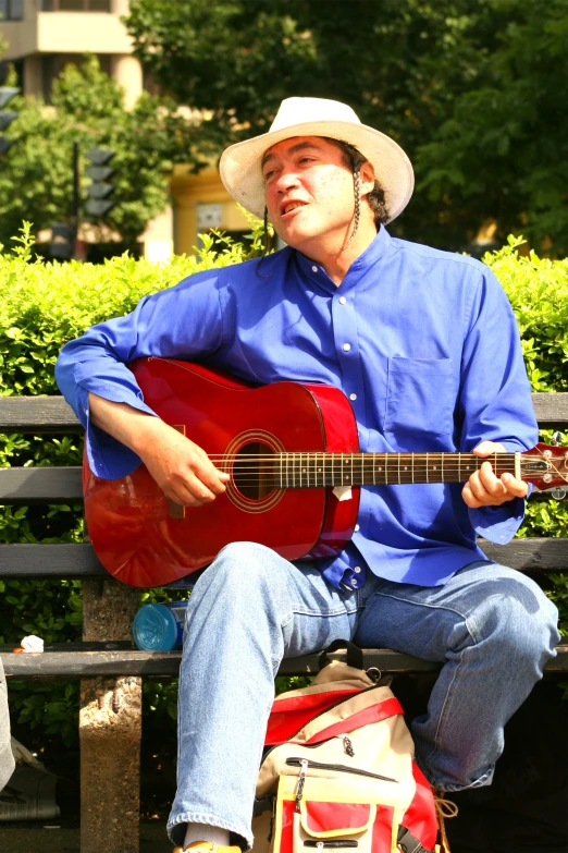 a person laying on the ground holding an acoustic guitar