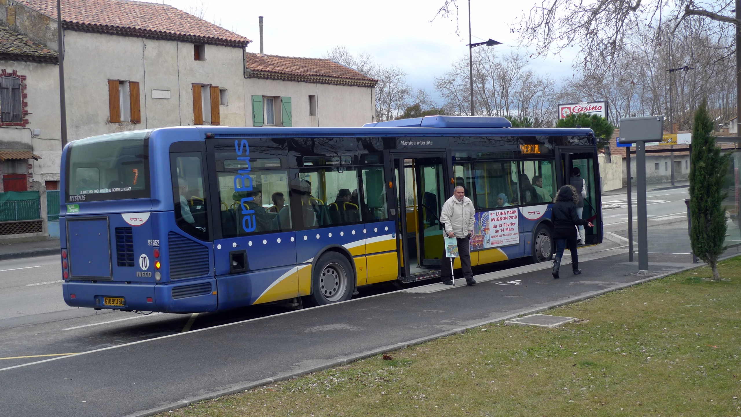 the city bus is waiting at the curb