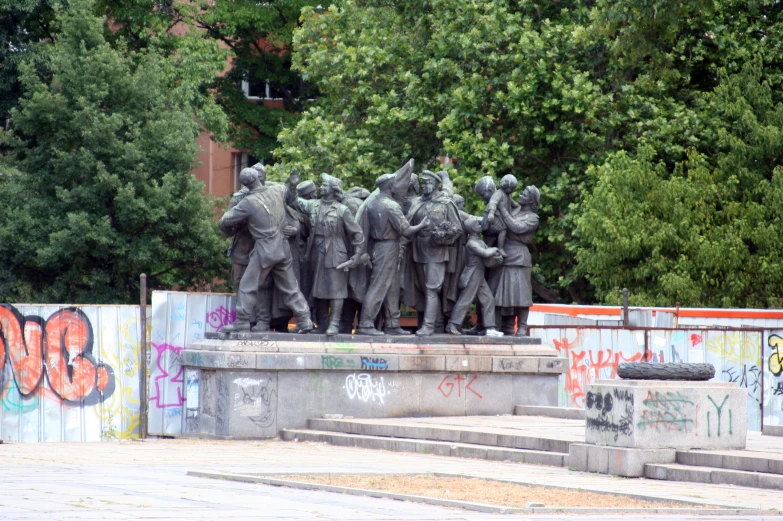 a group of sculptures of men walking down stairs