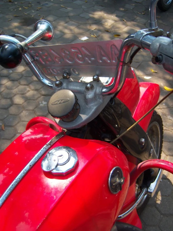 a close up of a red motor bike with the number one