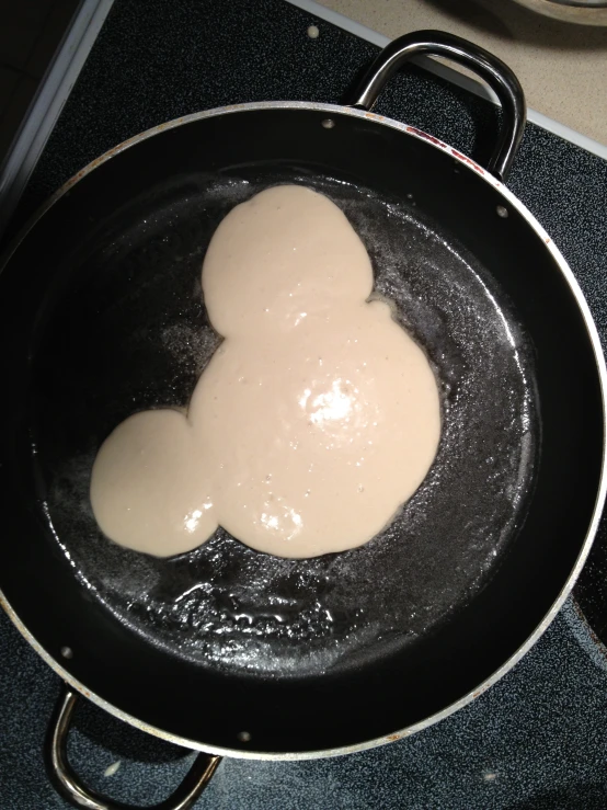 a pan filled with some type of food cooking on it