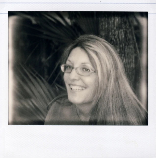 a black and white picture of a smiling woman