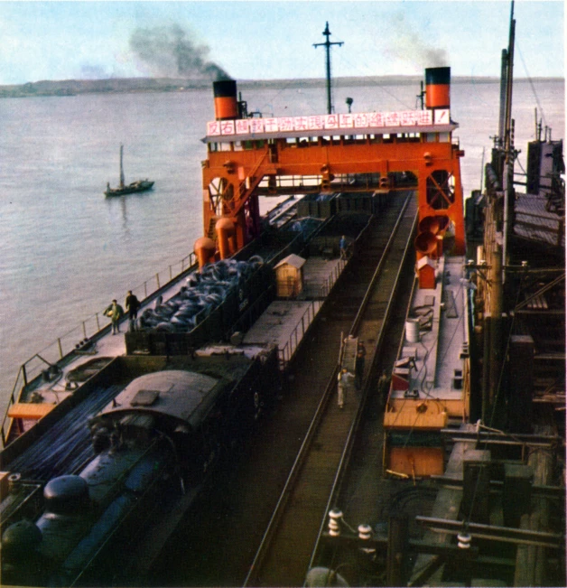 an oil tanker is carrying trains on the tracks