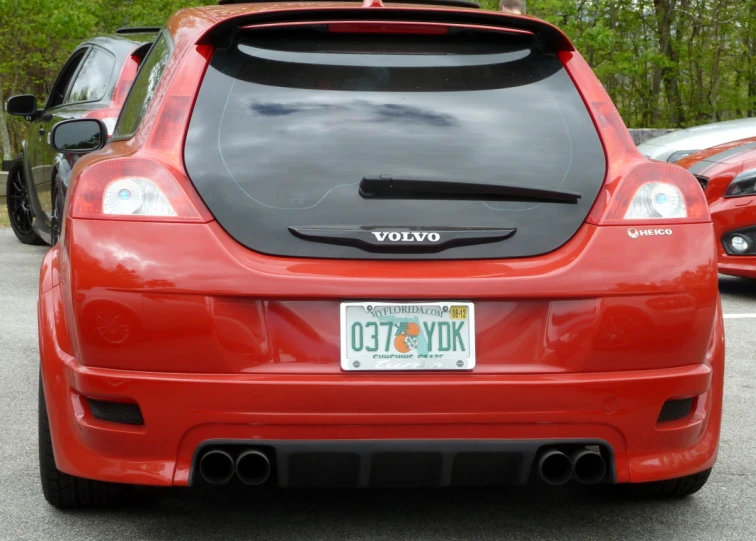 a car parked in a parking lot with other cars