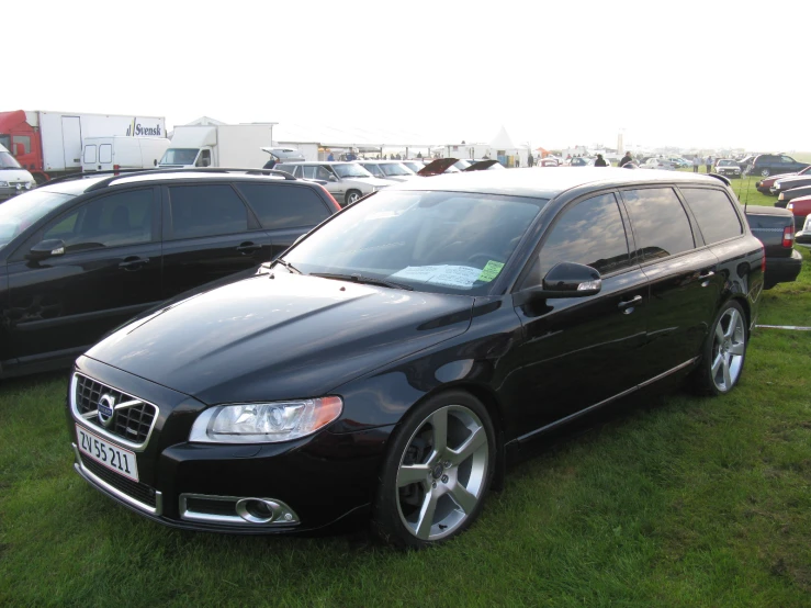 a large black vehicle parked next to another car