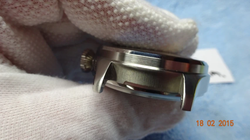 a silver metal band on the outer of a wrist