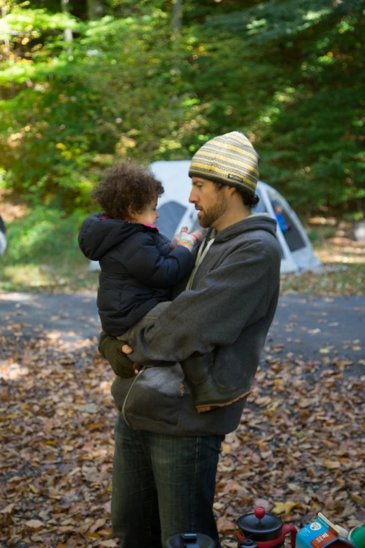 there is a man holding a young child