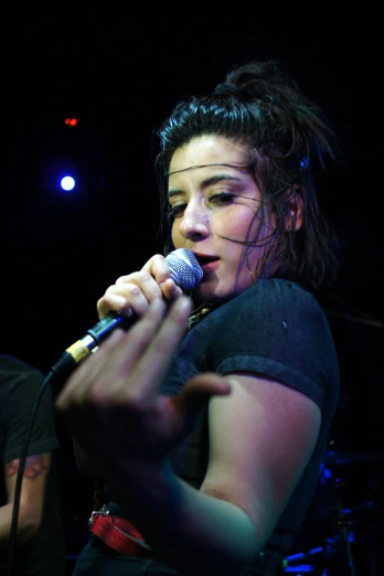 an image of a girl with microphone in the dark