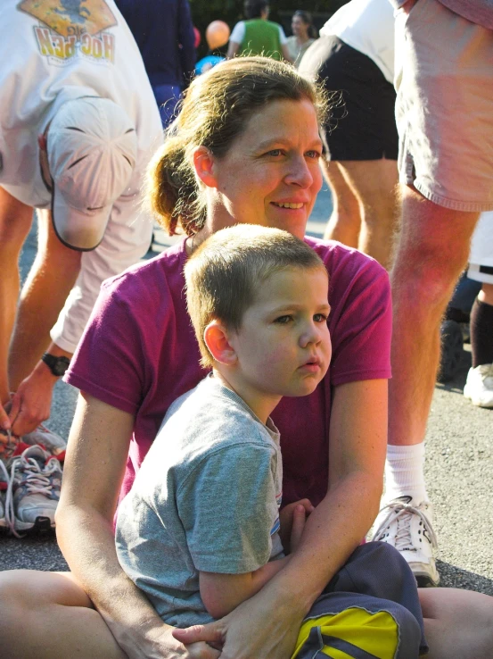 a  sitting with his mother in the street