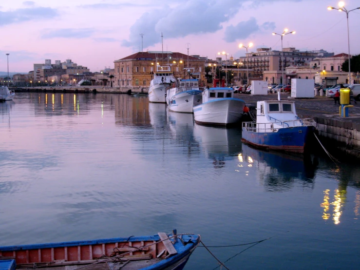 three boats docked at the dock in the ocean