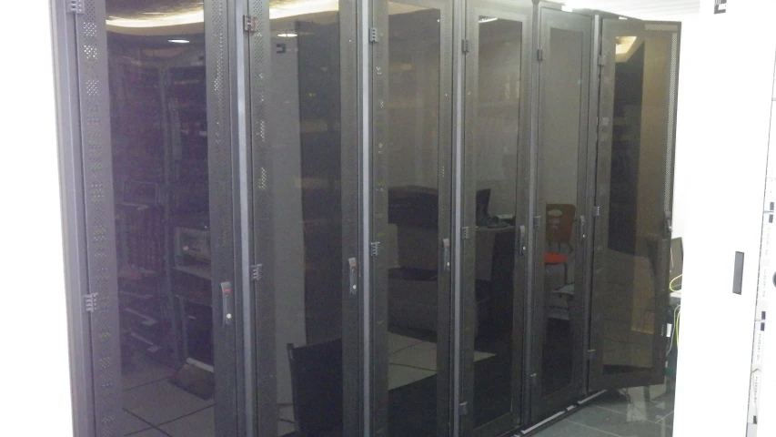 some servers in a row, behind glass walls