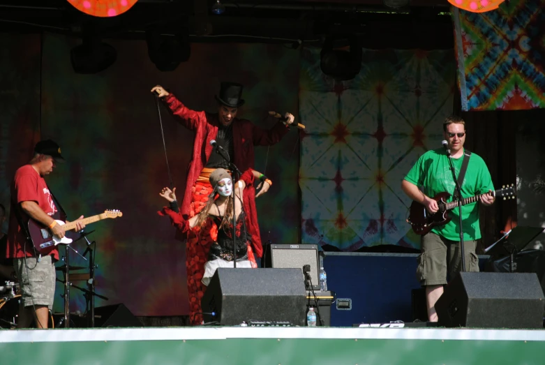 musicians in costumes performing on stage for an audience