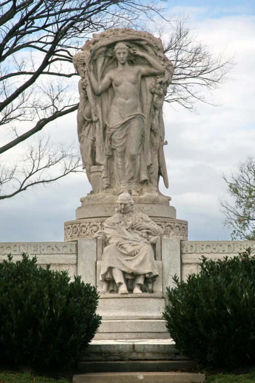 there is a statue near the trees in the park