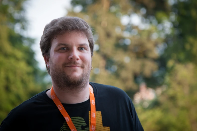 a man is holding onto an orange lanyard strap