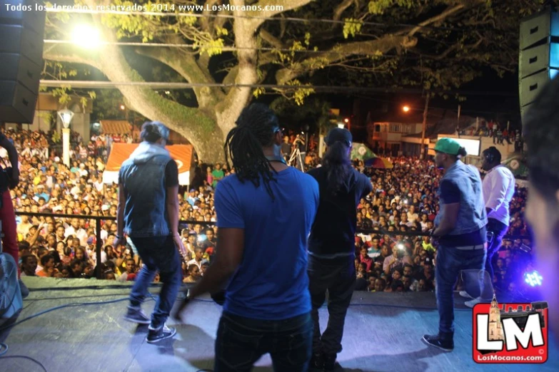 a couple of men standing on top of a stage