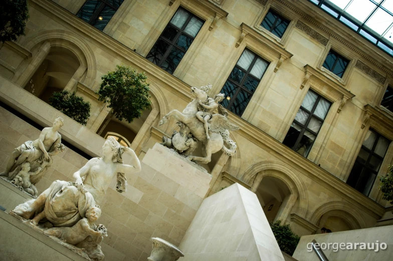 statues are shown outside of an old building