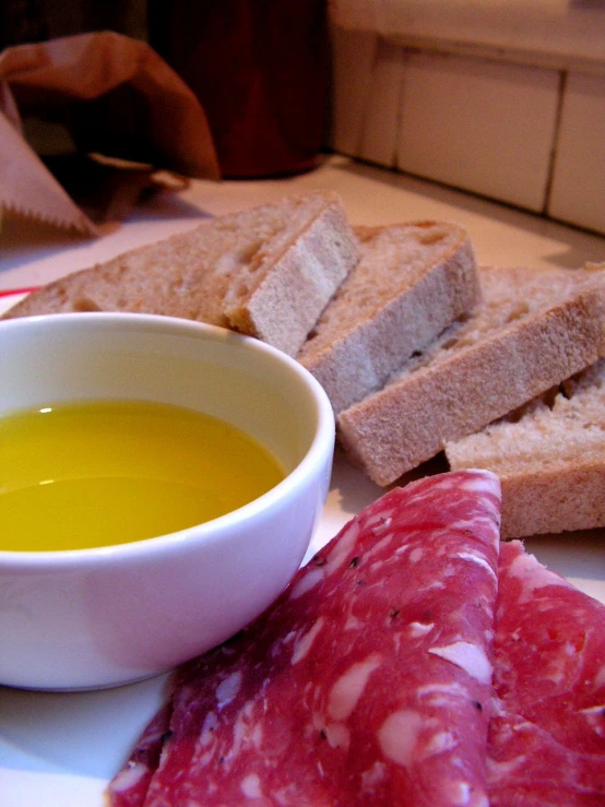 food with slices of bread and soup sits on the table