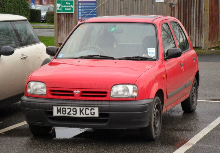 a car parked in a lot next to other cars