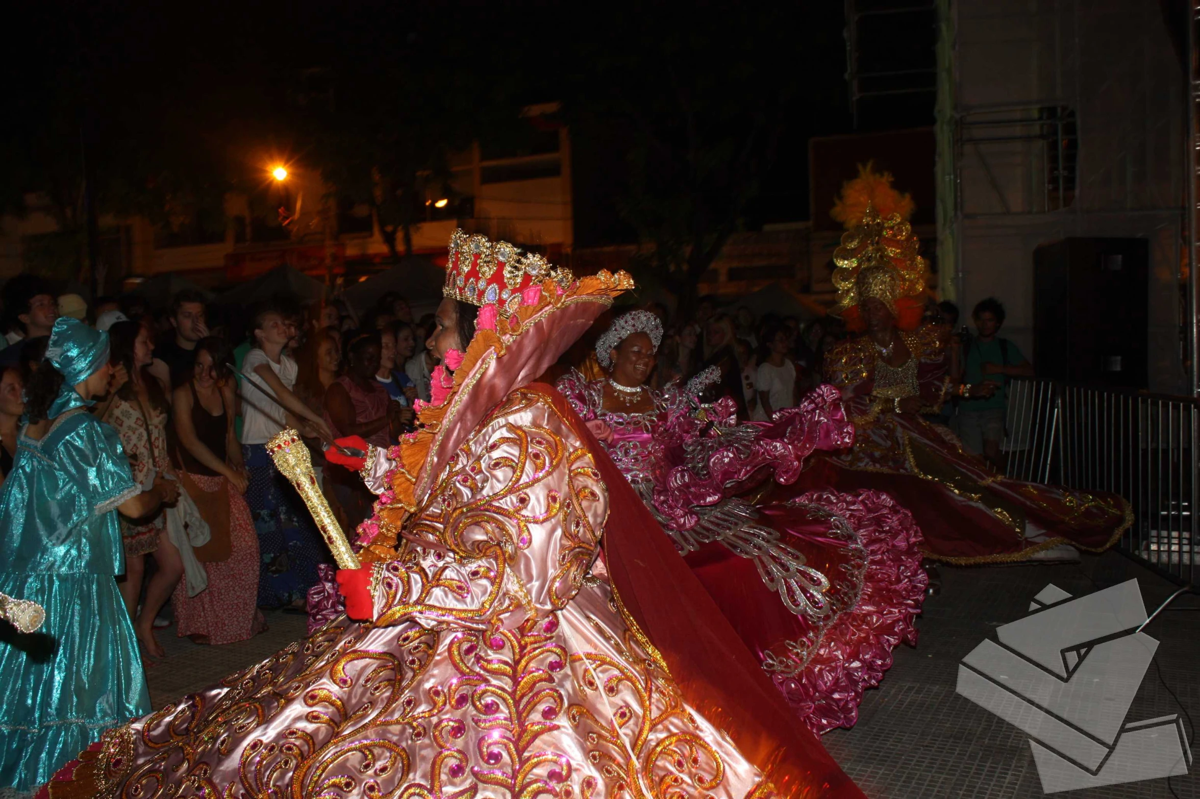 a colorfully dressed woman in front of a group of people