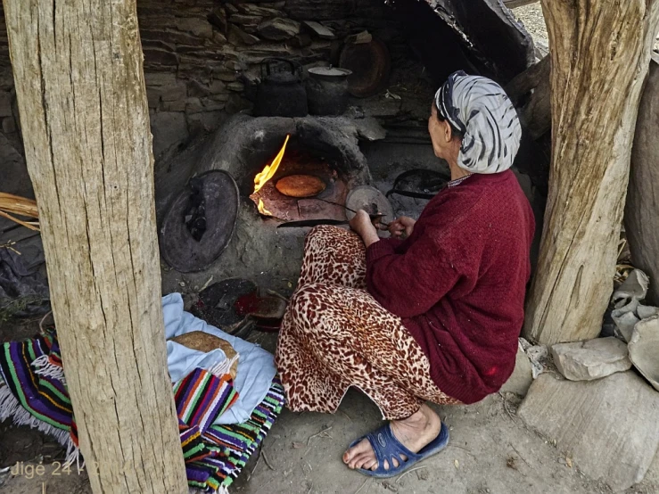 a woman in an area with a wood stove