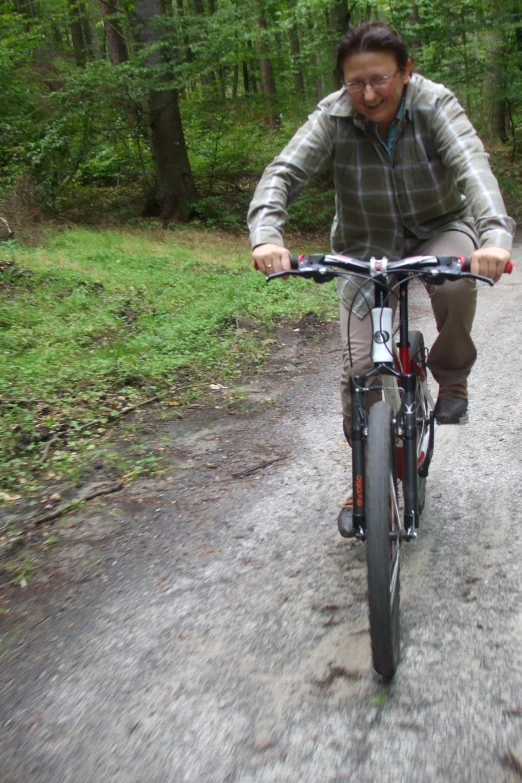 the man is riding a bicycle down the road