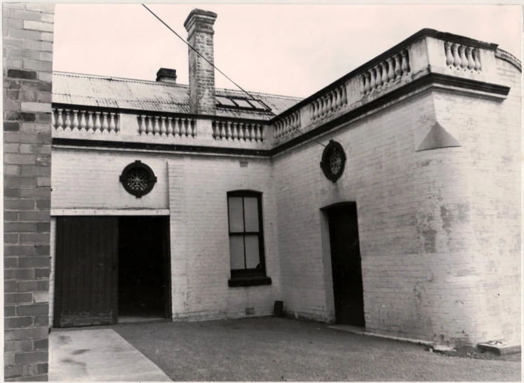 an old brick building with two tall clock faces