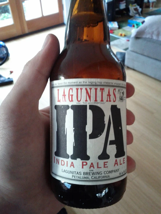 a person holding up a beer that says the hauntais hipa pale ale