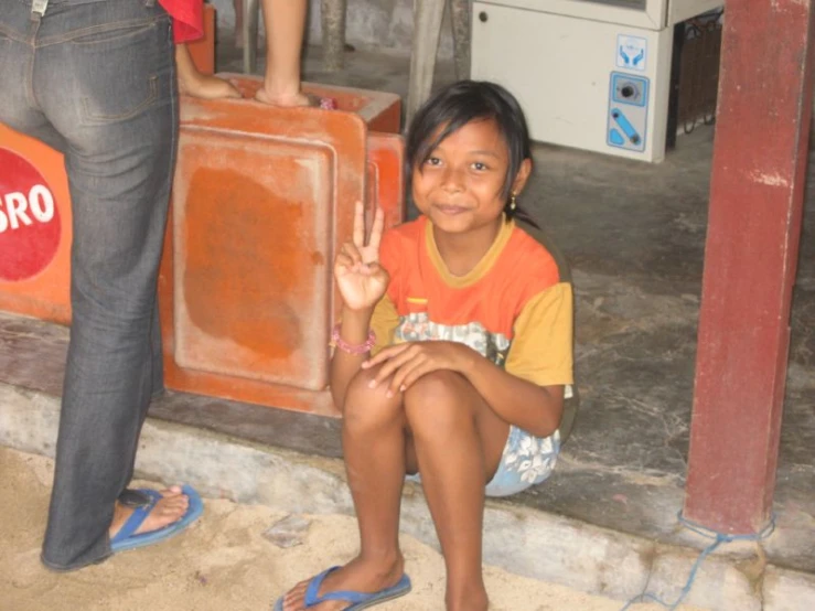 a girl that is sitting down with a suitcase