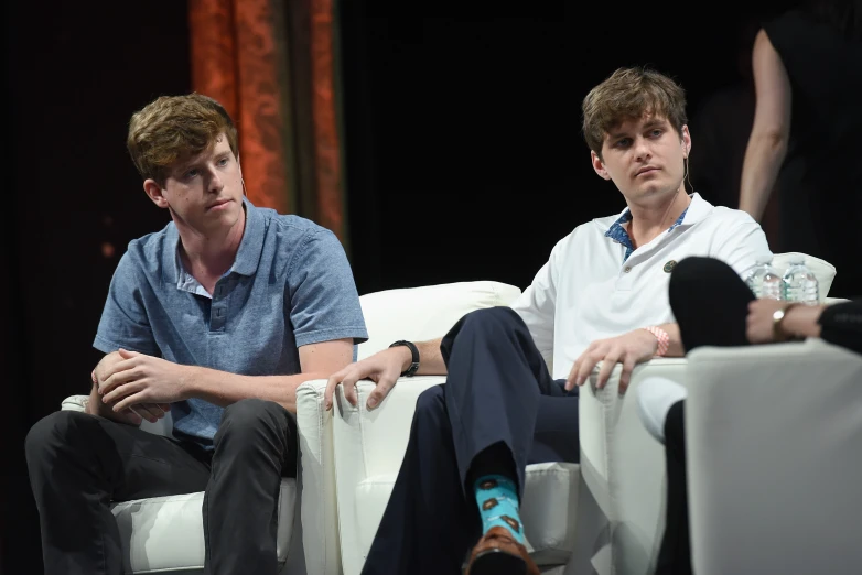 two people sitting next to each other in a chair