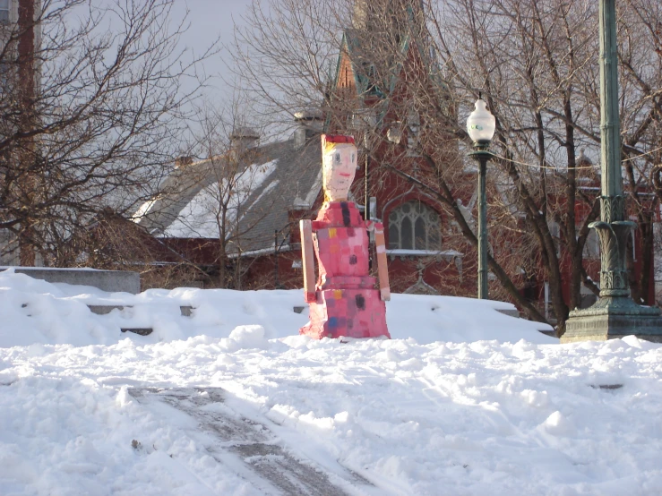 a pole with a mask on it, sitting in the snow