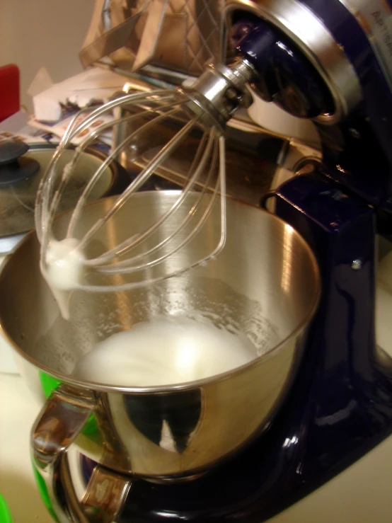 a kitchen mixer mixing cream in the kitchen